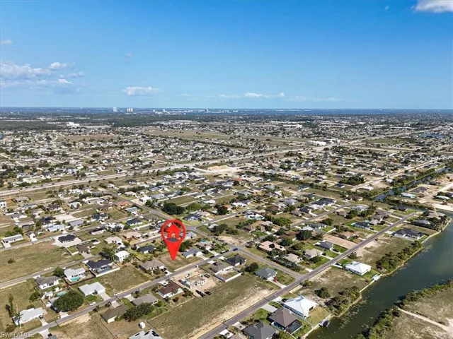 Aerial overview of property's location featuring nearby suburban area and a large body of water