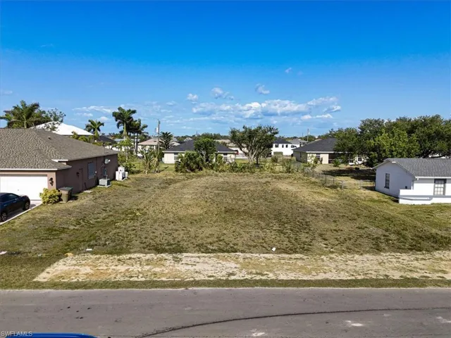 View of yard featuring a residential view and a garage