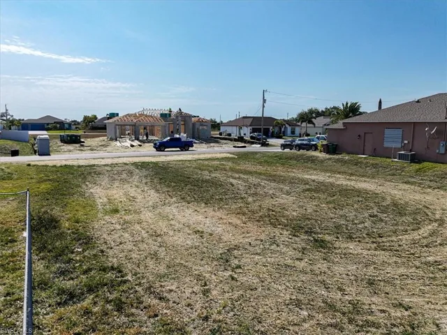 View of yard featuring cooling unit and a residential view