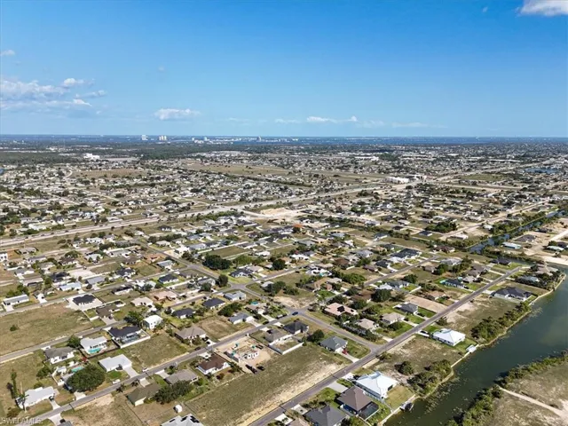 Aerial view of property's location with nearby suburban area and a nearby body of water