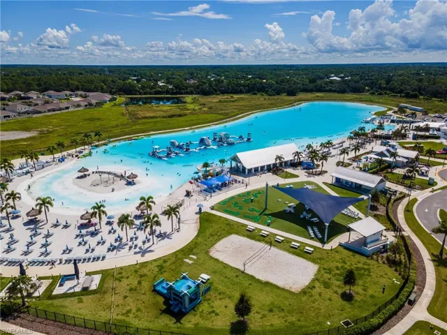 Expansive lagoon with sandy beaches, a water obstacle course, and mature palm trees