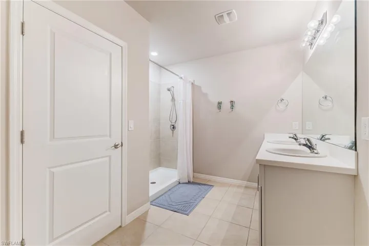 Dual sink vanity with chrome fixtures and integrated mirror