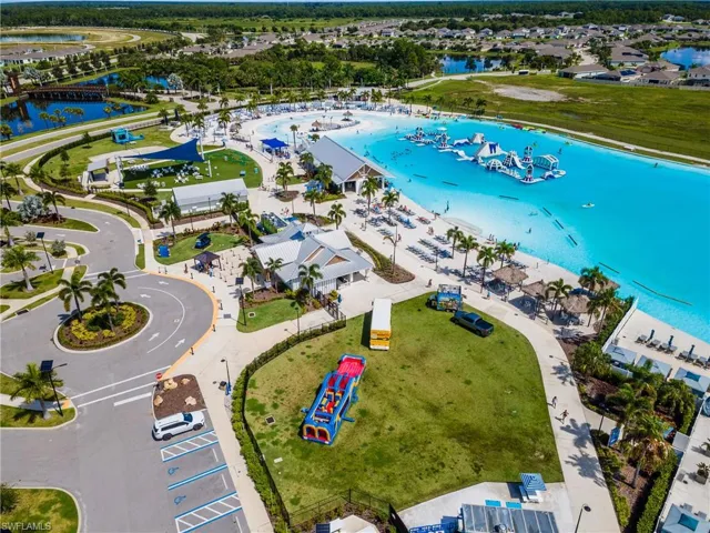 Expansive lagoon with water features, surrounding buildings, and manicured green spaces