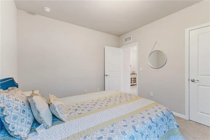 Neutral wall color, white trim, and light-colored carpeting