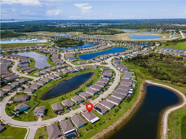 Aerial view of a residential community with multiple water features