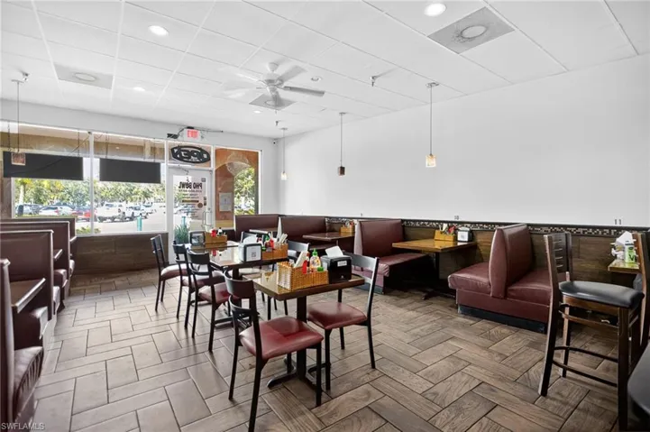 Dining space with a drop ceiling, ceiling fan, and recessed lighting