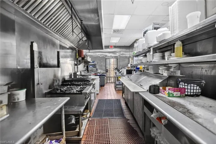 Kitchen featuring dark tile patterned flooring and a paneled ceiling