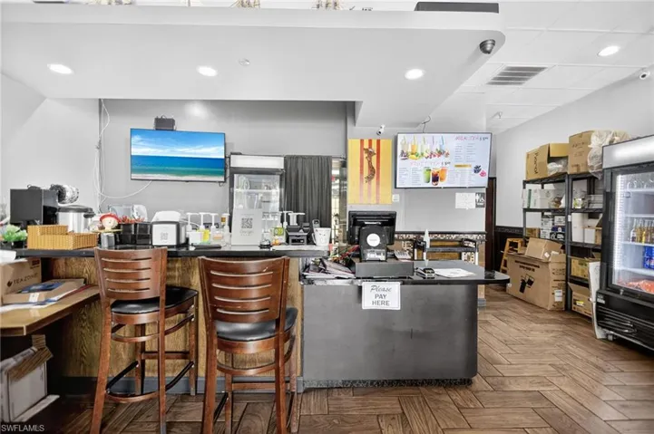 Kitchen with dark countertops, recessed lighting, and a peninsula