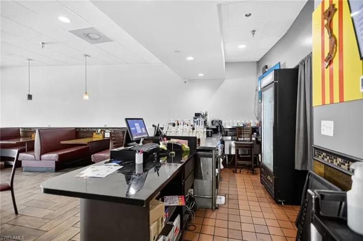 Kitchen with a drop ceiling, pendant lighting, open floor plan, light tile patterned floors, and recessed lighting