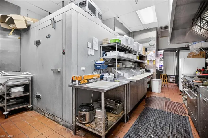 Kitchen with tile patterned flooring, a paneled ceiling, and range