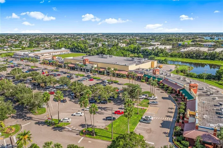 Bird's eye view of a commercial area and a tree filled landscape