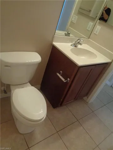 Third Bathroom with hand sink vanity and toilet featuring tile flooring