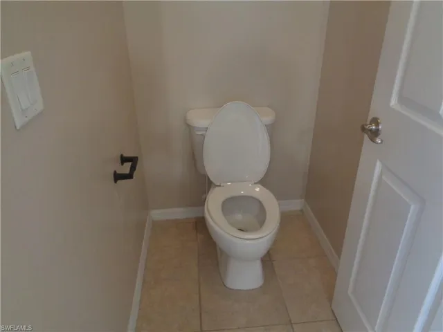 View of the Master Bedroom's bathroom with toilet enclosure and tile flooring