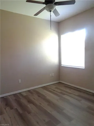 Guest Bedroom 3 with wood-like flooring and ceiling fan