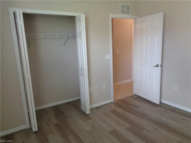 Guest Bedroom 3 with wood-like flooring and closet