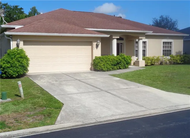 Front Left-side view of single-story home with a 2-car garage, driveway, shingle roof, and stucco siding