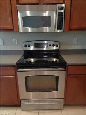 View of the stainless steel range/oven and microwave