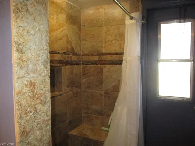 Full bath with a stall shower and healthy amount of natural light