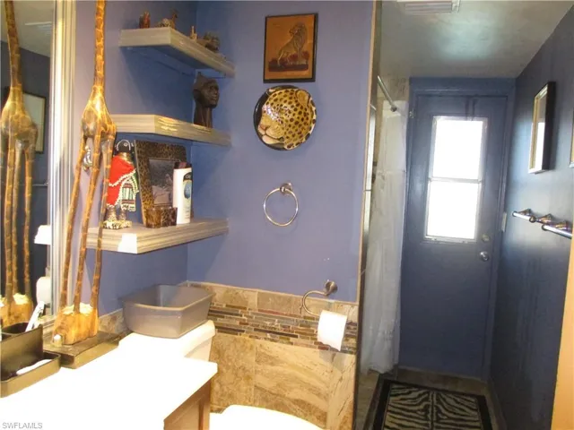 Full bath featuring a stall shower and vanity