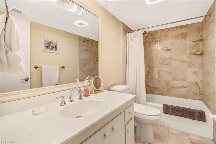 Bathroom featuring vanity and shower / tub combo