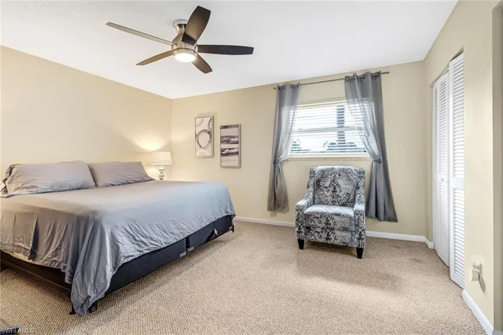 Bedroom with carpet flooring, a ceiling fan, and a closet