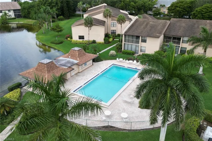 Community pool with a patio area and a water view