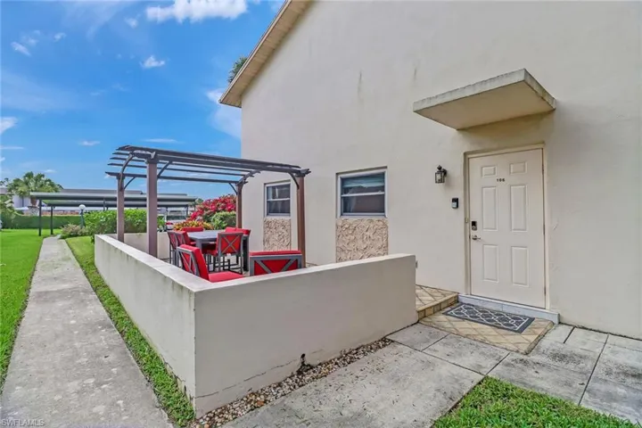 Property entrance featuring a patio, stucco siding, and a pergola