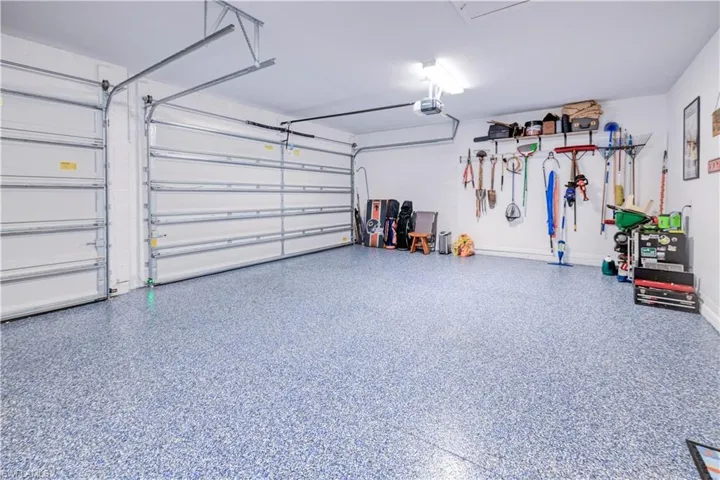 sought after 3 car garage with sleek epoxy floor finish