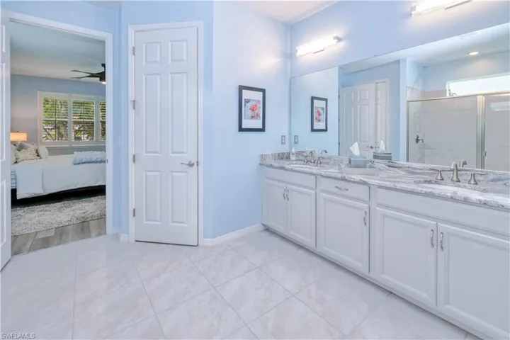 primary ensuite featuring dual vanity and water closet