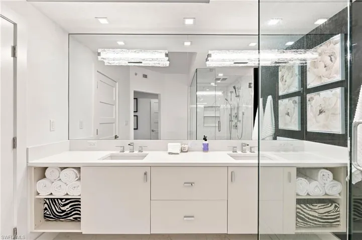 Spa-inspired primary bathroom featuring an expansive vanity with dual sinks, soft-close cabinetry, and generous storage