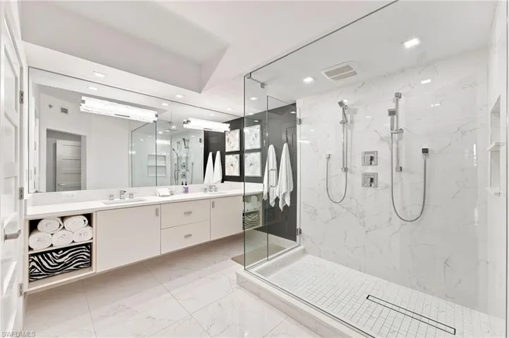 Dual vanity with undermount sinks, full-width mirror, and integrated storage