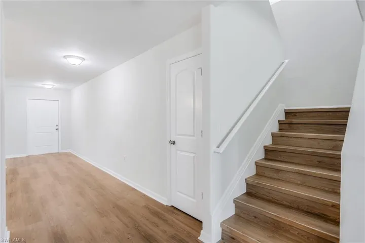 Staircase featuring light wood-type flooring