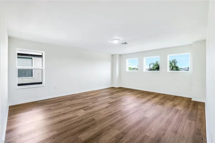 Unfurnished room featuring dark wood-type flooring