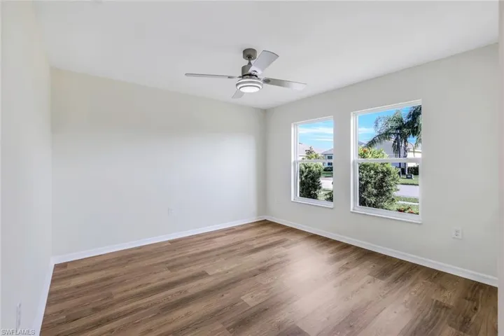 Unfurnished room with wood-type flooring and ceiling fan