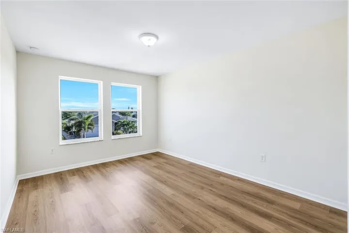 Unfurnished room with hardwood / wood-style flooring