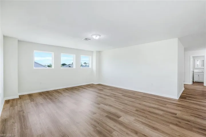 Unfurnished room with hardwood / wood-style flooring