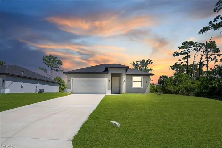 Contemporary single-story residence featuring a dark shingle roof and light-toned exterior