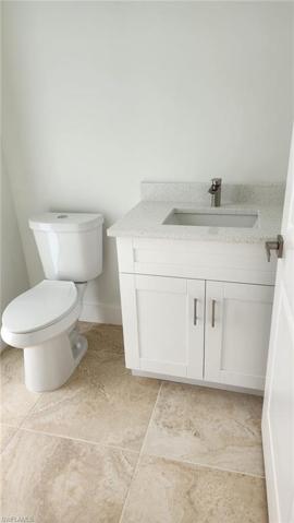 half bathroom with door to lanai
