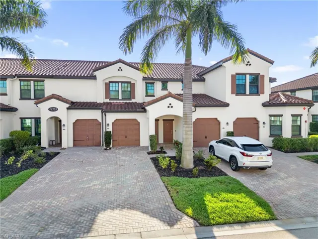 Mediterranean / spanish-style home featuring driveway, stucco siding, a tile roof, and a garage
