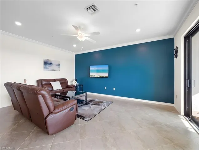 Living area featuring ceiling fan, ornamental molding, and recessed lighting
