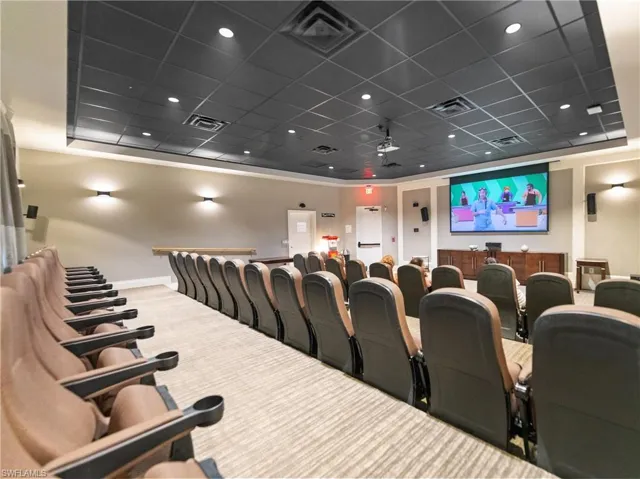 Cinema featuring carpet flooring and a paneled ceiling