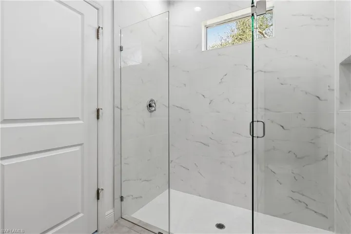 Bathroom featuring a marble finish shower