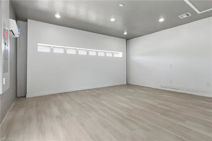 Empty room featuring recessed lighting, light wood-style flooring, and a mini split for heating / cooling