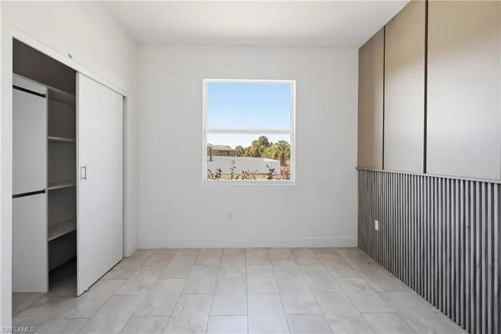 Unfurnished bedroom with baseboards and a closet