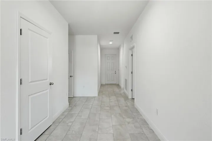 Corridor featuring baseboards