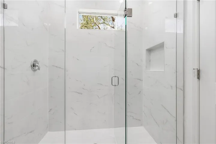 Bathroom with a marble finish shower