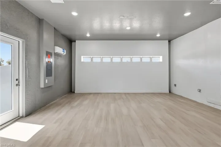 Unfurnished room with light wood-type flooring, recessed lighting, and a mini split for heating / cooling