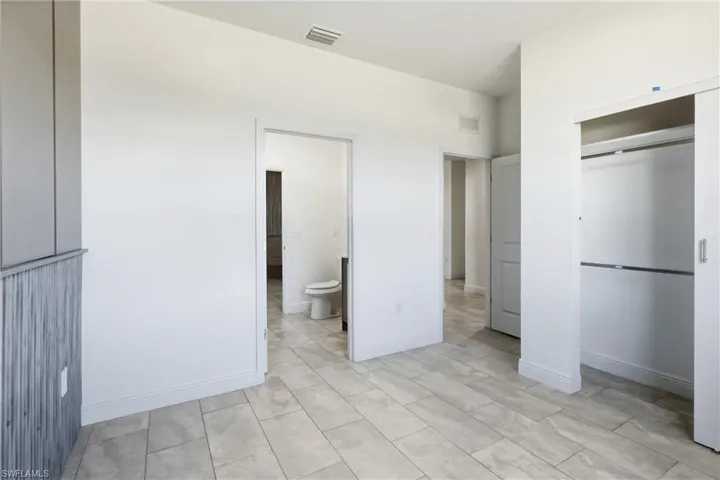 Unfurnished bedroom featuring baseboards and a closet