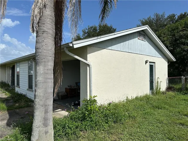View of side of home with stucco siding