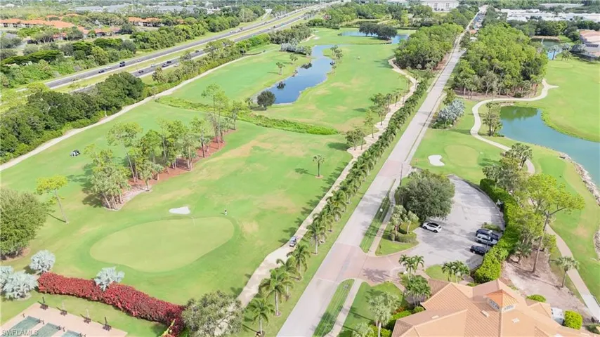 Drone / aerial view of a golf club and a nearby body of water